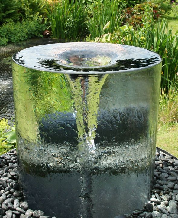 The stunning Volute water feature by Tills Innovations. A vortex being captured and displayed in clarity and detail. What appears to be a solid piece of glass with a spinning vortex. A mesmerising water feature.